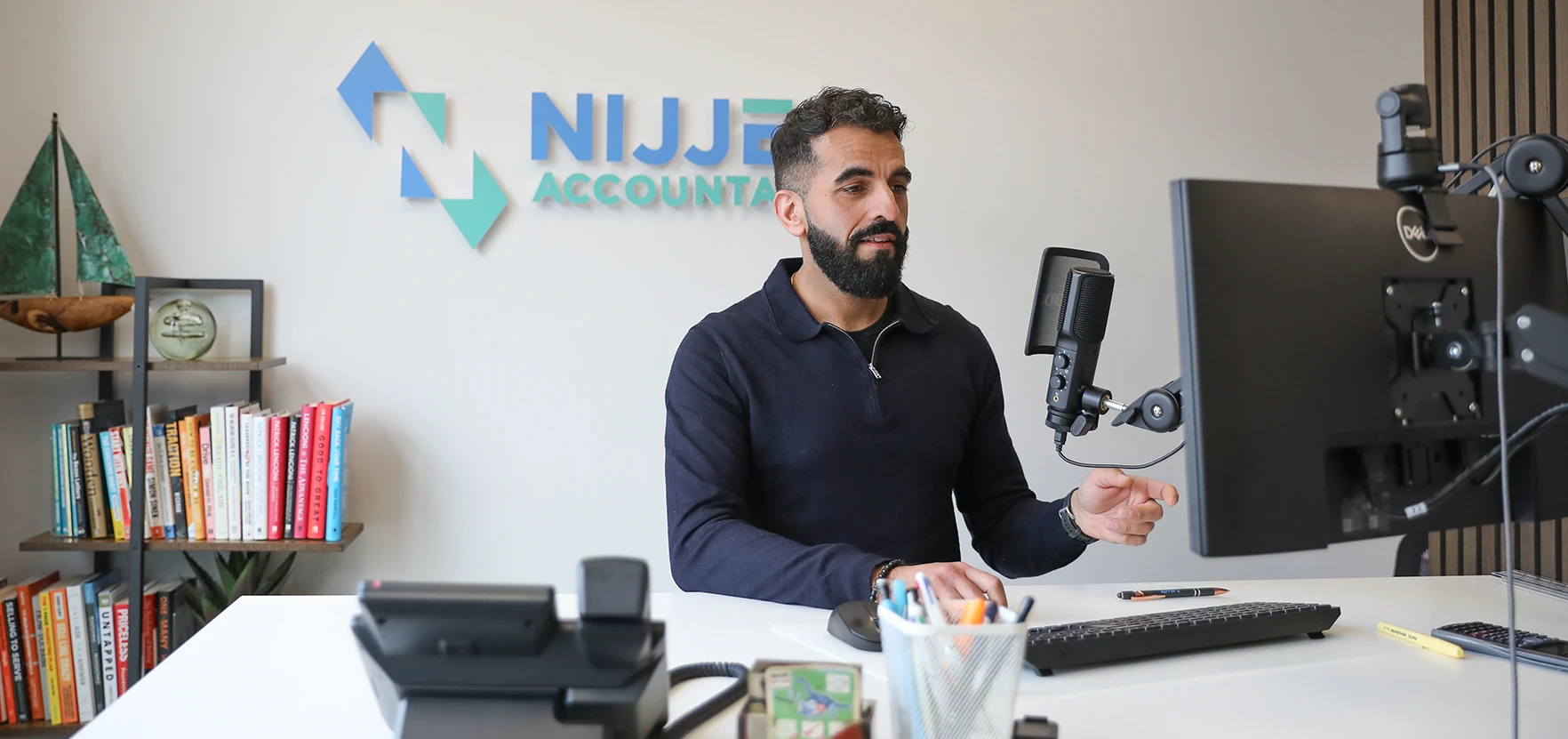 Tej Gill sat at his desk on an online business meeting